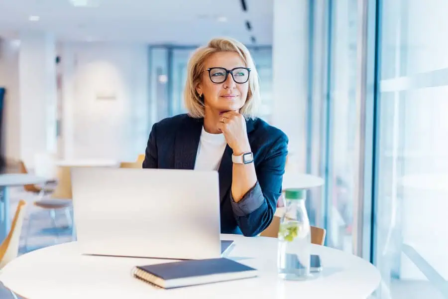 A woman at a table with a laptop.